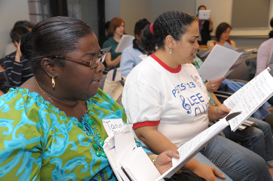 During a more traditional segment of the workshop, music teachers Tanya Brown Jeter (left) of PS 214 in Brooklyn and Yvette Torres of PS/IS 113 in Queens join colleagues in song. (Miller Photography)