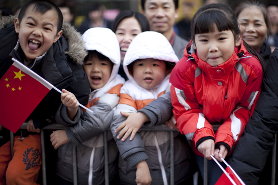 Along the parade route, children wait for their UFT pencils. (Dave Sanders)