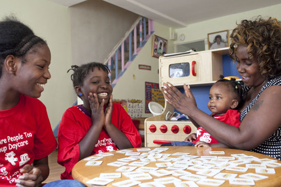 Queens provider Christina Winslow plays the educational game Memory with three o