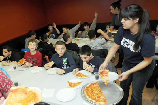 After the bowling there was pizza for everyone, as 5th-grade teacher Gabriella Vega handed out slices to the students. (Jonathan Fickies)