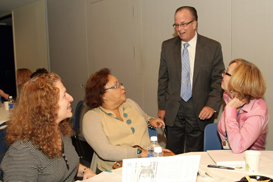 Welfare Fund Director Arthur Pepper (standing) chats with Danita Susi, a speech teacher at PS372 in District 75 in Brooklyn. Welfare Fund Director Arthur Pepper (standing) chats with Danita Susi, a speech teacher at PS372 in District 75 in Brooklyn; Florence Bianco, a speech teacher at PS 151 in in Queens; and Virginia Hill, a speech teacher at the Teachers Center. (Miller Photography)