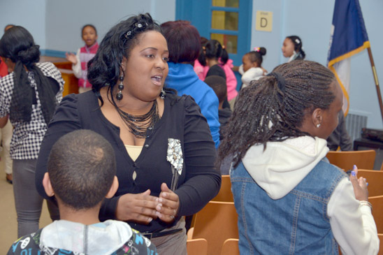 Teacher Roline Whyte leads her students in the morning song and dance. (Miller Photography)