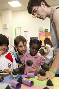 Kindergarten teacher Kori Goldberg and her students listen to 10th-grader Eddie 