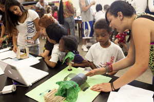 Children make the circuit and hear the pitches. Tenth-graders Christie Alvarez (