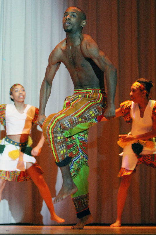 A student performs an African dance during a show.
