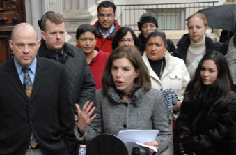 Menin, flanked by Mulgrew and others, addresses the press.