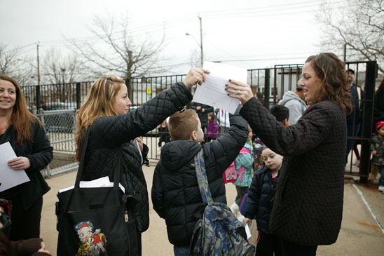 Third-grade teacher Stephanie Pascale hands a flier to a parent at PS 55 on Staten Island. Third-grade teacher Stephanie Pascale hands a flier to a parent at PS 55 on Staten Island. (Bruce Cotler)