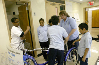Lockhart and kids make adjustments to the prize-winning solar-powered tricycle.
