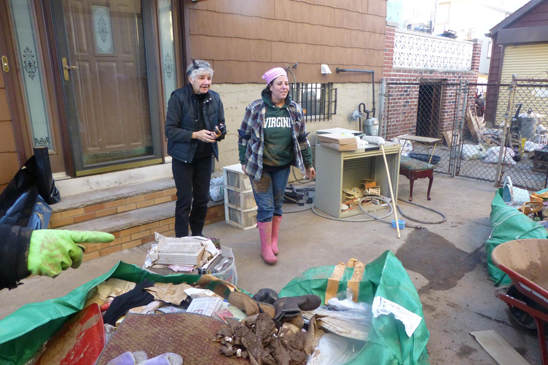 Lisa Cardieri (right), a nurse at Staten Island Hospital and a member of the Federation of Nurses/UFT, gets help cleaning up her storm-ravaged house from Federation of Nurses/UFT representative Kate Lombardi, a Visiting Nurse Service nurse, and other fellow nurses.