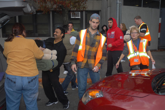 Tottenville HS football players, led by their coach, and community residents unload blankets for Hurricane Sandy victims Tottenville HS football players, led by their coach, and community residents unload blankets for Hurricane Sandy victims at the Staten Island school, which is serving as an evacuation site.