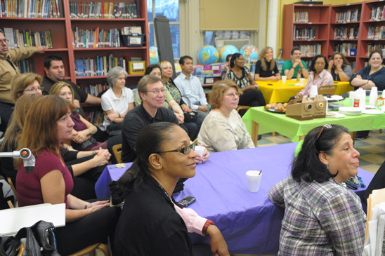 Staff at the two schools, PS 197 and IS 381, listen intently during the early morning meeting. Staff at the two schools, PS 197 and IS 381, listen intently during the early morning meeting. (Miller Photography)