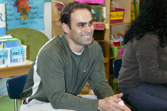 Teacher George Kakalos had his hand up to ask a question and appears satisfied with the answer.