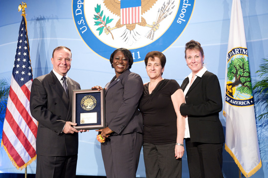 Among the Blue Ribbon winners honored at ceremonies in Washington, D.C. were (from left) Principal Jack Spatola, with Aba Kumi of the U.S. Department of Education, Parent Coordinator Annette Hendrickson and Assistant Principal Erika Gundersen of PS 172, Brooklyn. PS 172, Brooklyn: Among the Blue Ribbon winners honored at ceremonies in Washington, D.C. were (from left) Principal Jack Spatola, with Aba Kumi of the U.S. Department of Education, Parent Coordinator Annette Hendrickson and Assistant Principal Erika Gundersen of PS 172, Brooklyn. (Miller Photography)