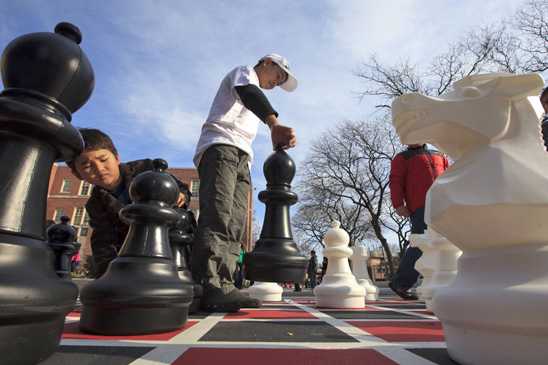 PS 173, Queens: Fifth-grader Lawrence and 2nd-grader Robert consider the next move at the opening of the school’s new play-ground that added to the celebration of being recognized as a school of excellence. PS 173, Queens: Fifth-grader Lawrence and 2nd-grader Robert consider the next move at the opening of the school’s new play-ground that added to the celebration of being recognized as a school of excellence. (Dave Sanders)