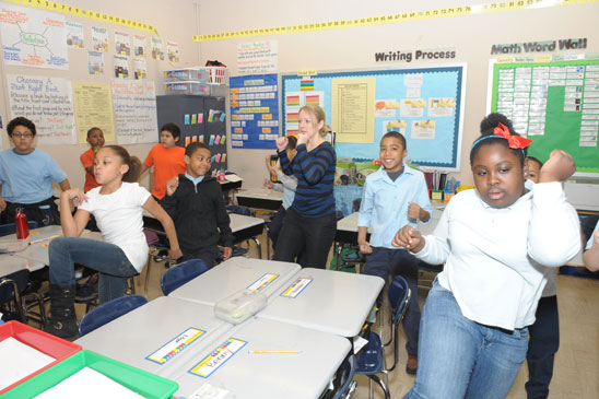 It’s elbow to knee to start the day in Bernice Patten’s 4th-grade class.