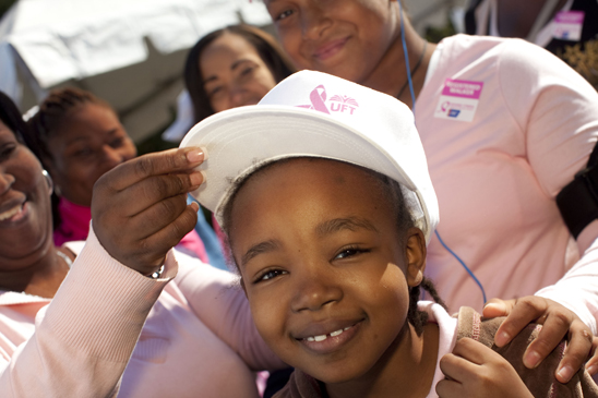 Maxine Lewis-Briggs, far left, ELA teacher at MS 484, Brooklyn, places a hat on Kayley Briggs, 7, at the Brooklyn Making Strides walk. Maxine Lewis-Briggs, far left, ELA teacher at MS 484, Brooklyn, places a hat on Kayley Briggs, 7, at the Brooklyn Making Strides walk. (Dave Sanders)