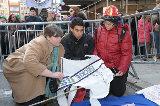 Teacher Maribeth Whitehouse with students James and Karina of IS 90 in the Bronx take a closer look at the shirtwaist motif posters. Teacher Maribeth Whitehouse with students James and Karina of IS 90 in the Bronx take a closer look at the shirtwaist motif posters. (Miller Photography)