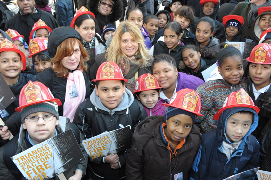 Teachers (from left) Milagros Ramirez and Cesia Ramirez with their PS 188, Manhattan students take in the ceremony. Students made their own posters in school and read articles and watched a documentary in their study of the Triangle Fire. Teachers (from left) Milagros Ramirez and Cesia Ramirez with their PS 188, Manhattan students take in the ceremony. Students made their own posters in school and read articles and watched a documentary in their study of the Triangle Fire. (Miller Photography)