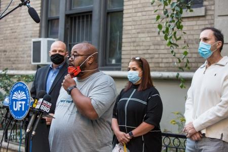 Allister Johnson (at microphone), the chapter leader at P811 in Manhattan, speaks about the first day back for District 75 students during a Sept. 21 press conference. Looking on are (from left) UFT President Michael Mulgrew and teachers Miguelina O’Connor and Steven Chirieleison.