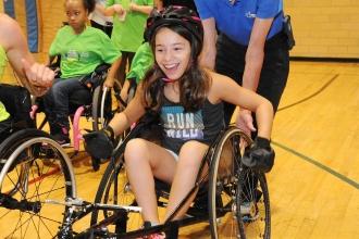 A student tries out a racing wheelchair.