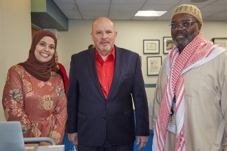 UFT Muslim Educator Committee Vice Chair Dina Hassan and committee liaison Aqeel Williams take a photo with UFT President Michael Mulgrew. 