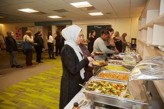 Attendees at the 2024 UFT Muslim Educators Committee grab food from the buffet.