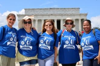 A group of UFT members take a group photo in front of the Lincoln Memorial 