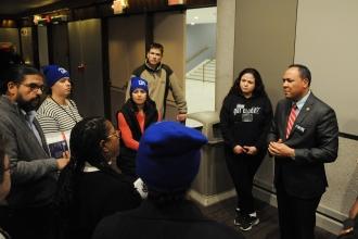 A group of members talk with a Bronx assemblyman