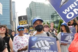UFT members hold signs in support of the writers strike 