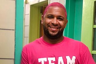 A school social worker shows up for the fight against breast cancer with pink hair. 