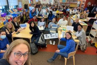 A group of teachers take part in Lobby Day virtually and pose for a group selfie in a classroom