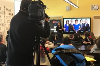 Camera operator filming in classroom 