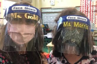 Teachers show off their masks and face shields