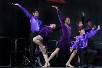 Student dancers wearing purple finish on stage