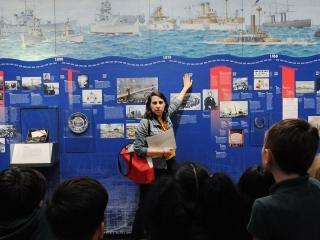 Museum educator Rebecca Saltzman and students discuss historical developments at