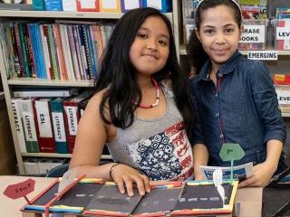 Third-graders Chloe and Giselle demonstrate their bascule bridge (also known as 