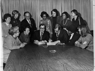 UFT President Albert Shanker (seated, third from left) and Joseph Monserrat, the