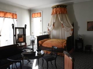 The master bedroom is furnished in the Classical style with pieces donated by va