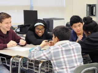  Middle school students work on probability problems with their tutors.