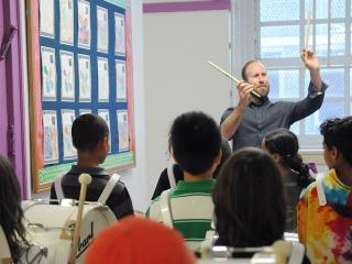 Music teacher Terry Campbell guides the students at a practice session.