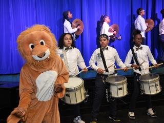 The PS/IS 184 mascot keeps the beat for the school’s drum line.