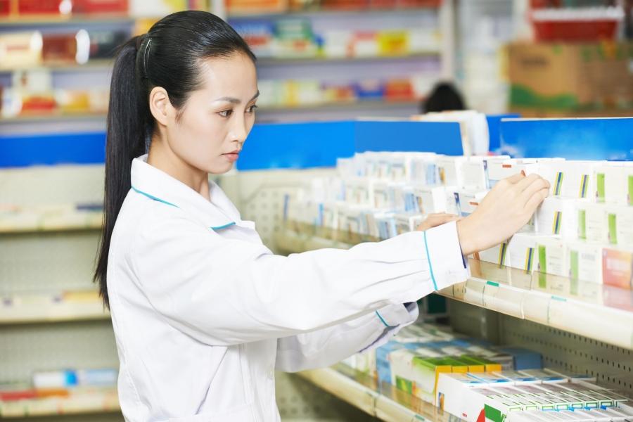 Asian women looking through prescriptions at a pharmacy