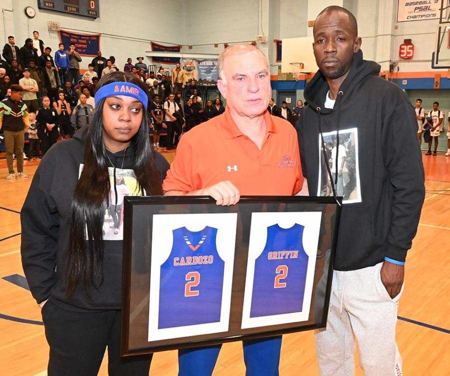 Cardozo HS varsity basketball coach Ron Naclerio (center) presents Aamir Griffin’s mom, Shanequa Griffin, and father, Warren Wells, with a plaque showing Aamir’s Cardozo jersey.