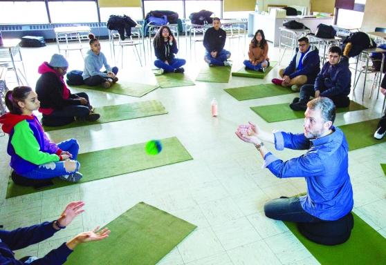 Students practicing mindfulness on yoga mats