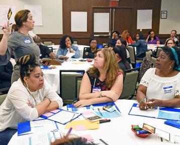 Laurie Hallick (standing) of the UFT Teacher Center leads the mathematics worksh