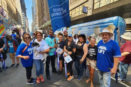Eight people from the UFT pose for a photo at the NYC Labor Day Parade.