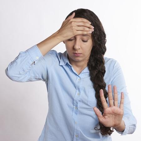Stressed women with hand on head and gesturing stop