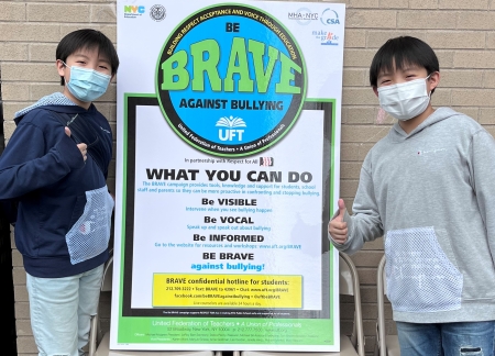 students with Be BRAVE Against Bullying poster