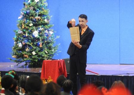 A magician dazzles kids with sleight-of-hand tricks at the UFT/Coalition for the Homeless holiday toy drive and celebration on Dec. 17, 2024