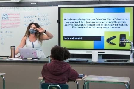 Teacher Victoriane Liz leads a discussion about budgeting with students during the advisory period.